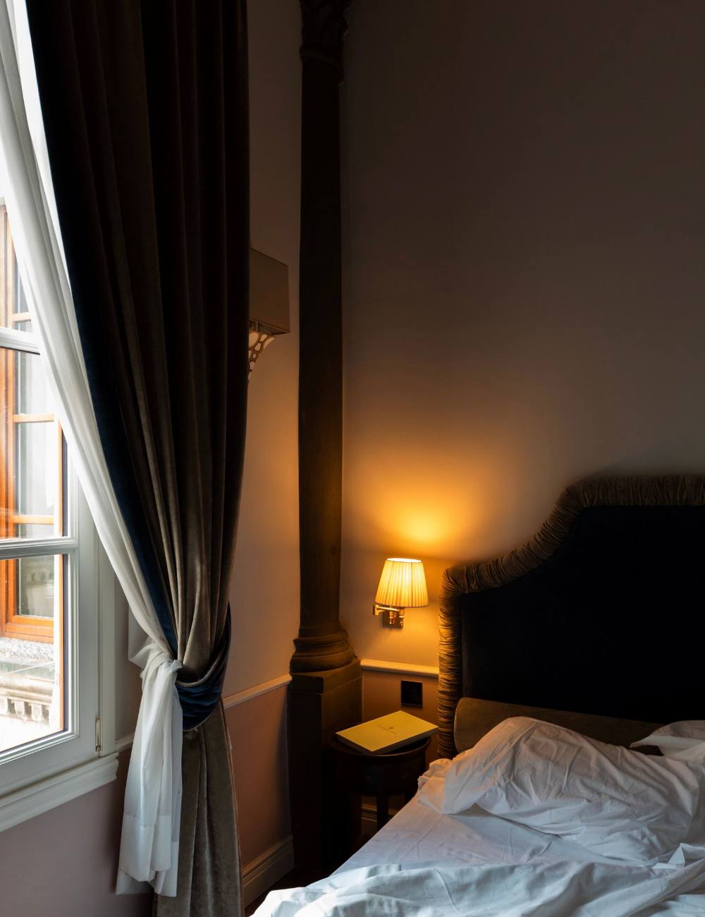 Coin avec rideau, lampe et fauteuil près de la fenêtre