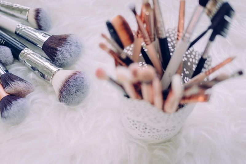 Brushes in a pot on a soft, pale surface