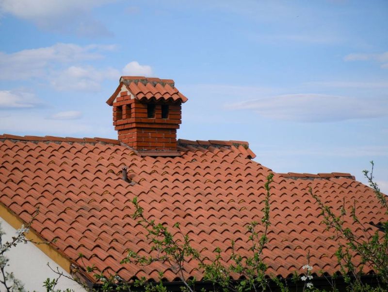 Brick chimney on a tiled roof